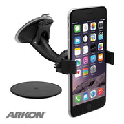 A smartphone is secured in a black Mobile Grip 2 Holder with Suction Mount, next to a round adhesive disk. The universal phone holder displays the ARKON logo in the bottom left corner.