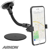 A black Mobile Grip 2 Windshield Suction Car Mount with 8.5 arm secures a smartphone displaying a map. The universal holder includes a round pad and features the ARKON logo in the bottom left corner. Compatible with iPhone, Galaxy, Note, and more.