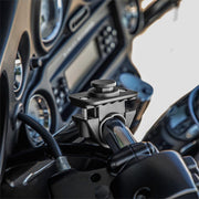 Close-up of the OCTO™ Series Motorcycle or Bicycle Handlebar Mount by Arkon Mounts attached to handlebars, with dashboard gauges visible. Features an octagon-pattern compatible design for secure device holding.