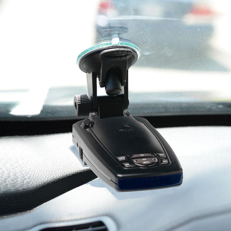 A black Radar Detector Mount for Windshield is attached above the dashboard, displaying a blurred traffic view through the windshield. This setup is compatible with Rocky Mountain Phantom-T radar detectors.