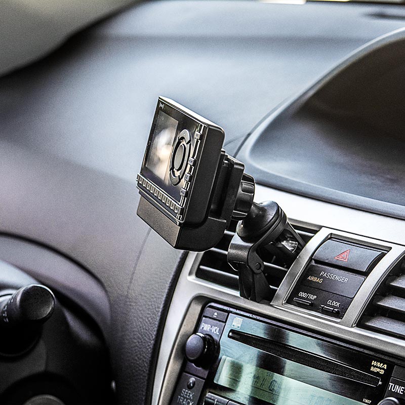 A close-up of a dashboard shows a Removable Swivel Air Vent Car Mount for XM and Sirius Satellite Radio securely attached above the audio and climate controls.