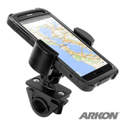 A smartphone displaying a map is mounted on the black RoadVise® Holder with Handlebar Mount, suitable for bikes, with the ARKON logo in the bottom right corner.