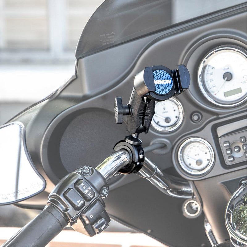 A RoadVise® Phone Holder with Aluminum Handlebar Mount and 2.75 Shaft is attached near the control buttons on a motorcycle handlebar, with the dashboard gauges and controls visible in the background.
