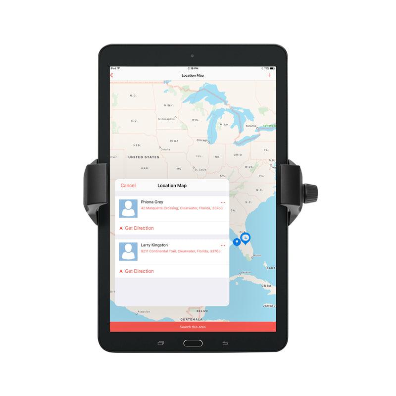 A black RoadVise® Ultra Phone and Tablet Holder secures a tablet showing a U.S. map with marked locations and pop-up directions for iPhone Grey in Clearwater, FL, and Larry Kingston in Crestview.