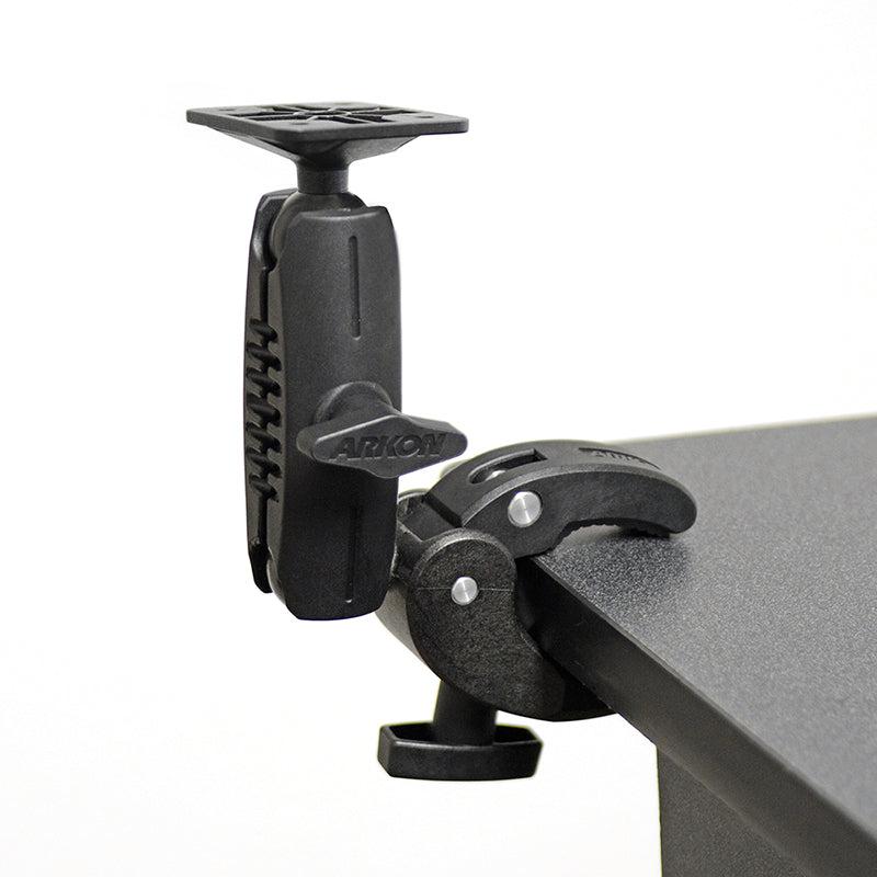 The Robust Clamp Mount with Security Knob - 4-Hole AMPS Compatible attaches to a table edge and features an adjustable, swiveling arm, security knob, and a top mount plate for securely holding your device.