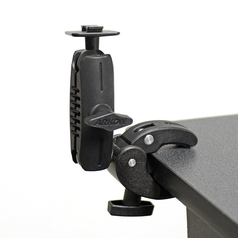The Robust Clamp Mount with Security Knob - Dual T-Tab Compatible attaches to table edges, features a rotating arm and screw knobs for secure support, and is ideal for holding cameras, tablets, or serving as a motorbike GPS mount.