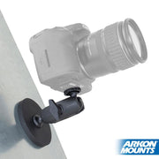 A DSLR camera is mounted on the Robust Magnetic Mount for Cameras and Video Cameras with a sturdy 1/4-20 pattern, attached to a flat surface. The Arkon Mounts logo is visible in the bottom right corner.