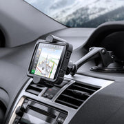 The RoadVise® XL Car Dash or Windshield Mount is attached above the air vents, securely holding a GPS device with navigation directions visible. A blurred winter scene is seen through the windshield.