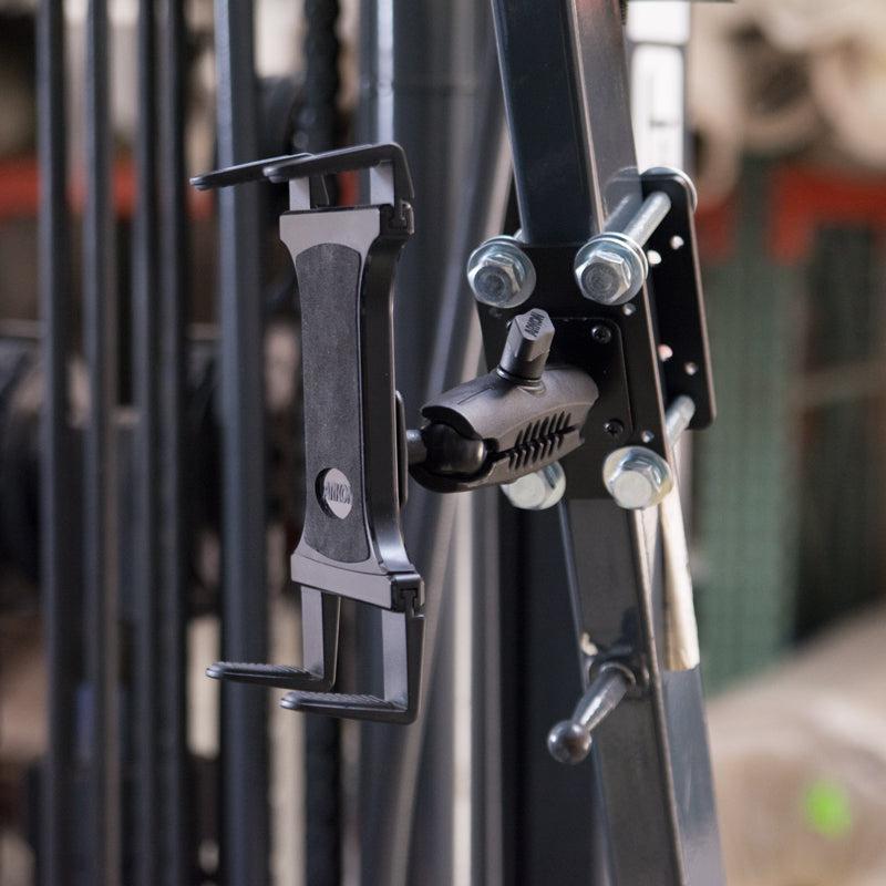 A close-up of the Slim-Grip® Tablet Holder with Forklift Front Guard Mount and 3.75 Shaft, securely fastened to gym equipment—highlighting its rugged, flexible design ideal for warehouse or forklift tablet mounting.