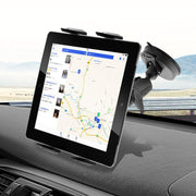 A Slim-Grip® Tablet Holder with Suction Cup Windshield Mount keeps a tablet upright on the car dashboard, displaying a map with driving directions while the road and landscape are visible outside.
