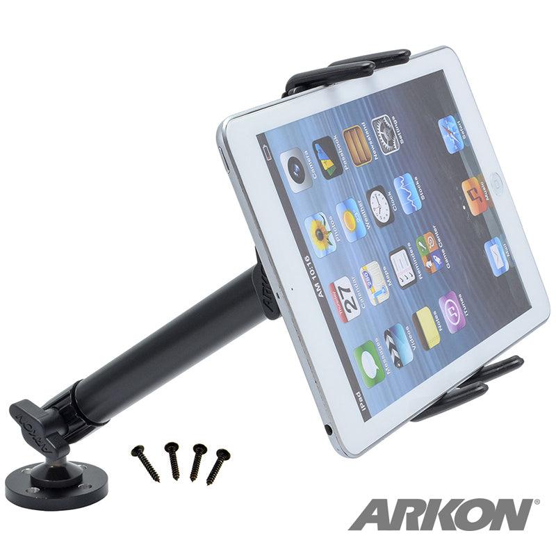 A midsize tablet is mounted on the Slim-Grip® Ultra Heavy-Duty Drilled-Base Midsize Tablet Mount with a black base and four nearby screws. The ARKON logo appears in the bottom right corner.