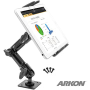 The Slim-Grip® Ultra Heavy-Duty Multi-Angle Midsize Tablet Drilled-Base or Wall Mount secures a tablet with charts and data, features four mounting screws and an AMPS pattern base. The ARKON logo appears in the lower right on a white background.