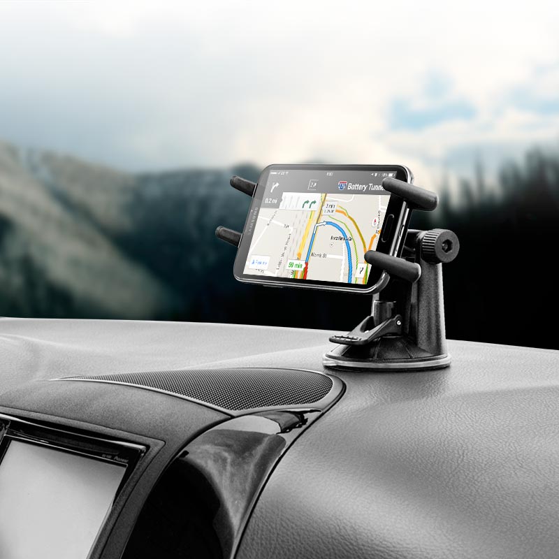 A smartphone with a navigation app is held in the Slim-Grip® Ultra Windshield or Dash Car Mount, featuring a suction base and 360° rotation, attached to a black dashboard with a blurred outdoor background.