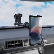 A Slim-Grip® Ultra Holder with Suction Mount holds a smartphone on the dashboard near the air vent, with a blue sky visible through the windshield.