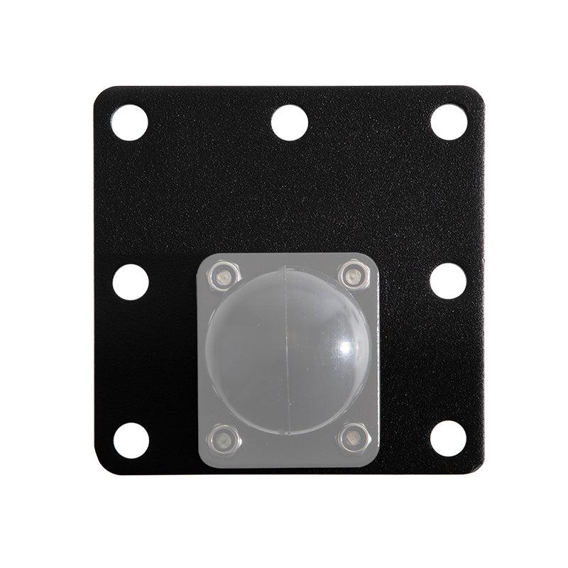 The Square AMPS Mounting Plate is a black, square metal plate with six round holes, a clear hemispherical dome near the bottom center, secured by four screws, and VESA 75 pattern support for versatile installation options.