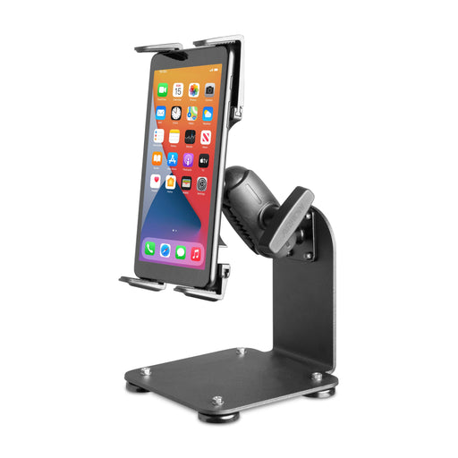 The SteadyMag™ Magnetic Mount System with Slim-Grip® Tablet Holder, inspired by warehouse designs, secures a smartphone with visible home screen apps on a sturdy black metal stand resting on a flat base.