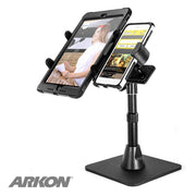 The black Dual Slim-Grip® Tablet Holder and RoadVise® Phone Holder with Desk Stand Mount keeps your tablet and phone side by side for streaming or content creation; the ARKON logo appears at the bottom left.