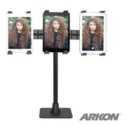 Three tablets on the TW Broadcaster TriStreamer Triple Tablet Holder 29-inch Stand, each showing a woman with long curly hair and a red streaming dot. The ARKON logo is at the bottom right.